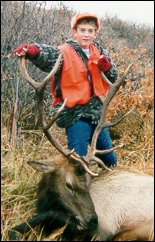 A happy young hunter with a fine bull