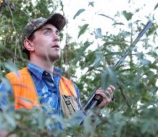 Kevin Lansing takes cover behind trees while dove hunting at Banner Lakes SWA. Photo by Jerry Neal (CPW)