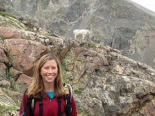 Shannon Schaller poses for a photo on a scouting trip for goats. Photo by CPW.