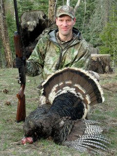 The author displays a Merriam's turkey he harvested in the San Juan Mountains.